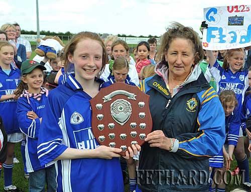 Fethard captain, Annie Prout, receiving the Ladies Under-12 County Plaque from County Board Representative, Biddy Ryan, following Fethard's win over Clonmel Og in the County Final played at New Inn last weekend.