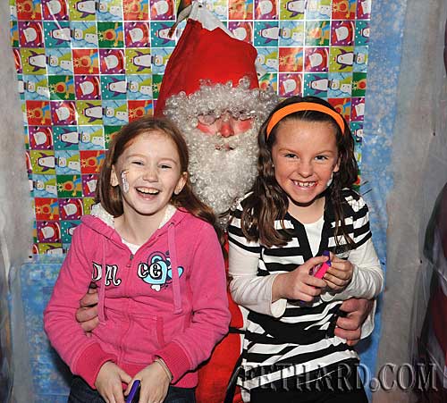 Visiting Santa at the Christmas Party at The Castle Inn Fethard are L to R: Holly Keating and Megan Earls