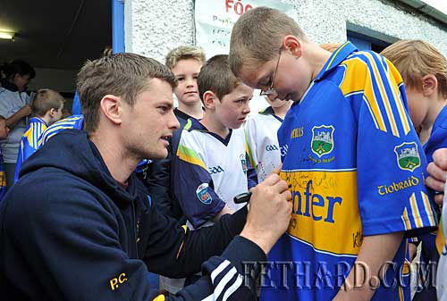 Tipperary hurling star, Paul Curran, signing autograph for Harry Butler at Fethard Juvenile GAA VHI Cúl Summer Camp