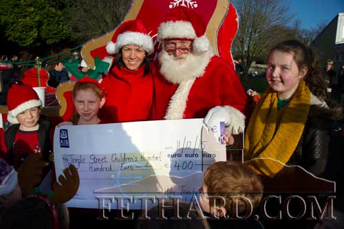 Holy Trinity National School Fethard pupils and principal, Ms Triona Morrisson, presenting a donation of €400 on behalf of the pupils to Santa for Temple Street Hospital.