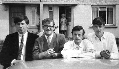 The late Eamon Maher photographed with his friends outside Conor Lanigan's house, Árd Mhuire, Thurles, in 1965. L to R: Bill Maher (Main Street), Michael Maher, Eamon Maher and Conor Lanigan.

Michael Maher has finally solved the identity of the mystery man in the photo after receiving a phone call from an old acquaintance who saw the photo on the internet and opened the conversation with the words, "God didn't we all look well in that photo!"

His name is Conor Lanigan from Árd Mhuire in Thurles and the photo was taken in 1965 by the late Liam Whyte (Main Street) outside Conor's house in Thurles with his mother in the background. The group were more than likely heading off to a dance in the Premier Ballroom later that evening.

Michael's memory was jogged by the fact that Stephen (Fitzgerald) rang him to say that he had met Maureen Whyte while out walking last week and informed him that she had also found the photo while sorting out some of Liam's possessions. It's amazing how little reminders can unleash many other memories as Michael had never seen the photograph before and wasn't sure where it was taken.