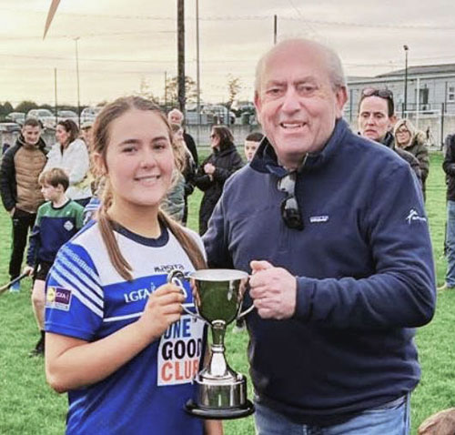 Meadbh Collum lifting the County Title Cup for Fethard Ladies Football U16 team.
