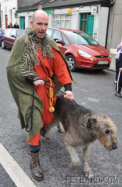 Fr. Anthony McSweeney C.C. leading one of the wolfhounds in the Medieval Parade