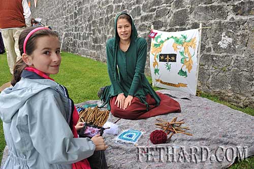 L to R: Sadhbh Marshall and Gráinne Wilson practising their craft by Fethard Town Wall
