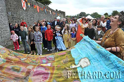 Pat Looby helping to raise the childrens 20-foot 'Medieval Tapestry' on to the Mural Tower at Fethard Town Wall