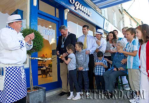 Cllr Michael Fitzgerald, National President of the Association of County and City Councils, cutting the tape at the official opening of Jimmy O'Brien's new butcher shop 'Meat on the Square' in Fethard.