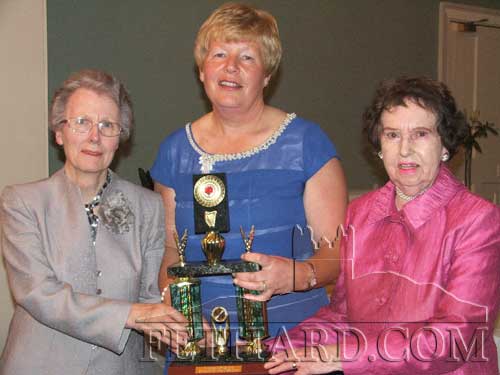 Ann O'Dea, Club President, presenting the Lucey Trophy to Berney Myles (left) and Alice Quinn (right)