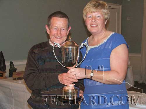 Michael Kenny accepteing the Kitty Hayes trophy for Club Championship, from Ann O'Dea, Club President. Michael's partner for the championship was Tony Hanrahan