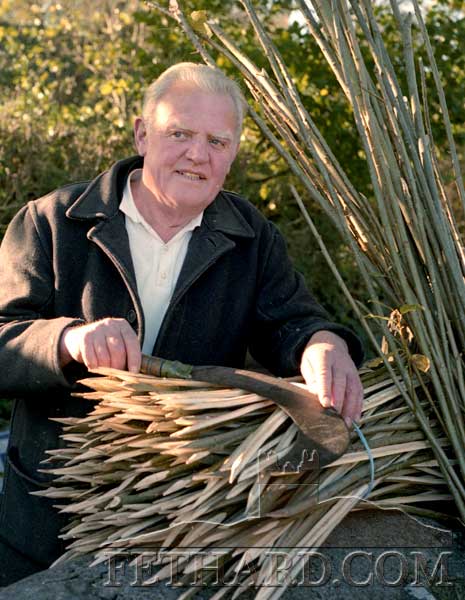 The late Dick Cummins, Cashel Road, Fethard, pictured outside his own house cutting rods from his osier beds nearby, November 1989.