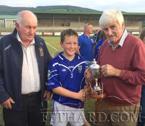 Conor Neville being presented with the South U12 B Hurling Champions cup.