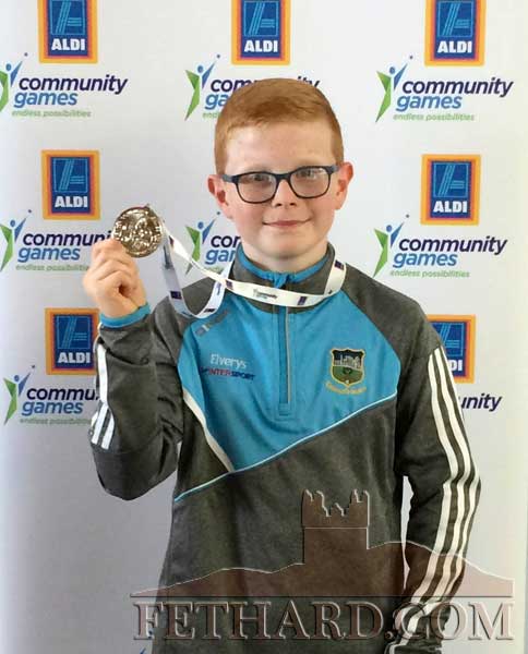 Mark Oâ€™Meara holding his silver medal won in the boys U12 Handwriting event at the Aldi Community Games National Finals.