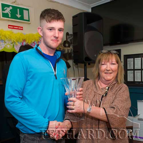 The winner of the Butler's Bar Fethard Sports Achievement Awards for January, Paul Moloney, receiving his award from Ann Butler.