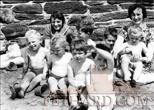 James Burke (USA) posted this photograph of his mother, Breda Burke (back left) with Rita O'Shea and their children from left, James Burke, Joe Burke, Mary Burke, Richard Burke, Catherine O'Shea, Patrick O'Shea and John O'Shea. The foot in the sand (on right) belongs to a buried Martin O'Shea. Taken in Tramore in the sixties.