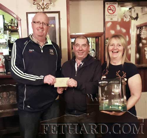 Colm Hackett (centre), winner of â‚¬500 First Prize in the Fethard GAA Christmas draw, receiving his cheque from club chairman, John Hurley. Also included the photograph is promoter Marie Smith, representing the Well Bar. Marie was presented with a Christmas Liqueur Set kindly sponsored by Merryâ€™s Clonmel 