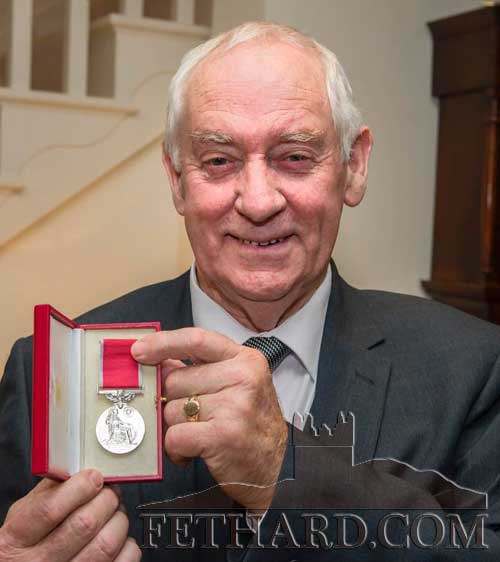 John Looby photographed with his British Empire Medal in recognition of his work for the local community.