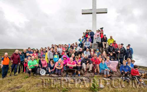 Walkers make their way to Holy Year Cross on Slievenamon (Photographs â€“ Slievenamon)
A slight shower didn't dampen the spirits of our walkers as they made their annual way to the Holy Year Cross ion Slievenamon on Sunday, August 11. The group, led by Fr. Liam Everard PP, gave a rousing rendition of â€˜Slievenamonâ€™ before they headed back to O'Donnells field where Mass was celebrated by Fr. Liam, assisted by Fr. Tom Breen and Fr Iggy Oâ€™Donovan OSA. 
After Mass everyone enjoyed the tea and refreshments on offer. No one is sure where all this food comes from but it is hugely appreciated and thanks to one and all involved. This year we saw many new faces on the walk, and it is great to see parents bringing their young children to the event, you are giving them memories that will last a lifetime.
Our thanks firstly to our hosts the O'Donnell family for the use of their field every year, thanks also to the Fethard Scouts and the Fethard and District Day Care Centre. It is almost impossible to name all who help make this event materialise, but thankfully, that list is getting longer each year and believe me we need each and every one of you.
Next year will mark the 70th anniversary of the erecting of the first Cross on Slievenamon, and we hope that many of you will be able to join us on this special day where we will remember all those who began this tradition and say thanks to all of you who turn up, year in year out.  You keep this great Parish tradition alive.
