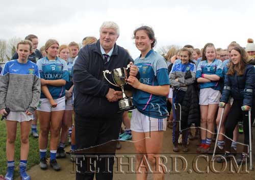 Team captain Lucy Spillane receiving the Munster Cup from Liam Shinnick, Vice President Munster Ladies Football Association