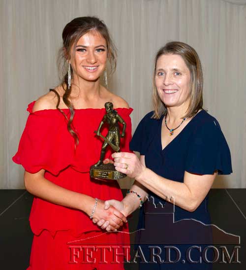 Nell Spillane who won U16 camogie player of the year receiving her trophy from Paula Bulfin.