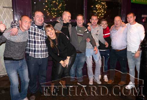 Annual visitors to Lonergan’s Bar, Fethard, for the past four years are this group of ‘lads’ from Carrick-on-Suir who appear to have fallen in love with the St. Stephen’s Day atmosphere in the town. Photographed above with proprietors, Roseann and John Carroll.