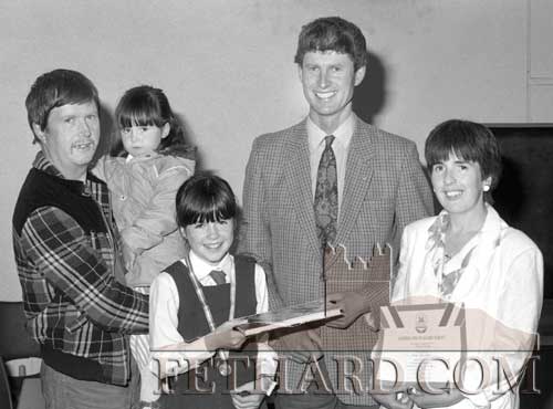 Mr Joe Prendergast, presenting Aisling Neagle for best individual effort the Nano Nagle National School’s World Book Club ‘Partners in Excellence’ promotion in the school, June 1991. Also included in the photograph are Aisling’s parents, Kay and  John Neagle, holding their baby Aoife.