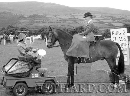 Mrs J. Wilkinson, winner of the Side-Saddle Class 21 event for 4-year old ponies and over, sponsored by Mr & Mrs E.J. O’Grady, Killeens, Ballynonty, being presented with her prize at Killusty Pony Show, held on Saturday, July 11, 1987.