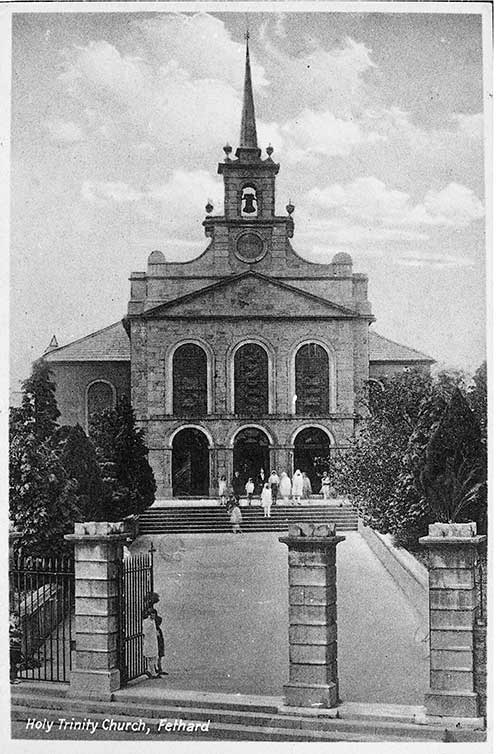Postcard of Holy Trinity Parish Church exterior with front gates and children after their First Holy Communion at church door