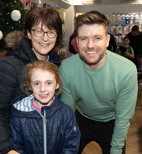Entertainer and musician, Johnny 'B' (O`Brien), photographed with fans, Laura Allen and Kim Allen (front), at the official opening of the renovated Dalton's Pharmacy in Fethard.