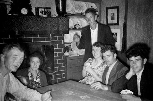 Playing cards at the kitchen table at Knockelly are: Jack and Kate Myles, Billy Lawless (standing), Bernie Myles, Paddy Fitzgerald and Michael Keane.