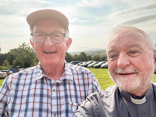 Tommy Healy (left) photographed with Archbishop Kieran O’Reilly after Mass celebrated in O’Donnell’s field when pilgrims returned from Holy Year Cross on Slievenamon on Sunday, August 17.